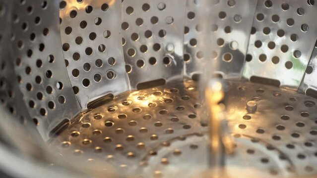 Water is poured onto a silver folding steamer basket - closeup