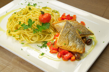 fish grilled pike-perch fillet paprika-olive ragout with spaghetti with chili, garlic and anchovies seafood