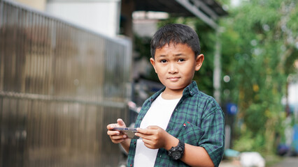 Portrait of asian boy using smartphone in outdoor
