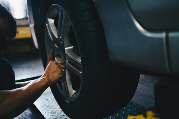 Mechanical man maintenance car brake and fix in tire shop