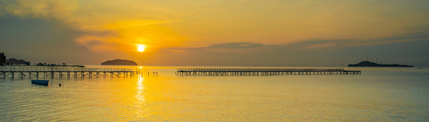 Sunrise with a broken pier at the coastline in Raja Ampat