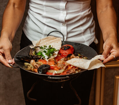 lamb meat sliced in layers with vegetables according to Azerbaijani national dish called Sadj