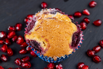 Wheat fresh cupcake with cherry and red pomegranate