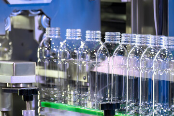 The  empty drinking water bottles  on the conveyor belt for filling process.