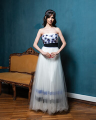 Fototapeta premium A woman in a white dress with blue flowers