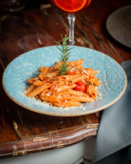 Italian cuisine pasta in tomato sauce with parmesan cheese