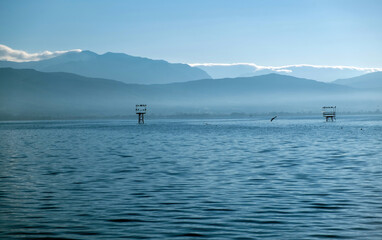 Greece Pamvotis Lake, Ioannina city Epirus. Iron construction accommodate bird, blue sky background.