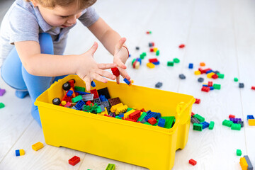 The child plays as a constructor. Selective focus.