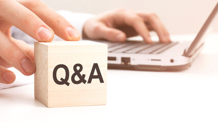 Q and A text wooden block on white table background. Idea, strategy, advertising, marketing,...