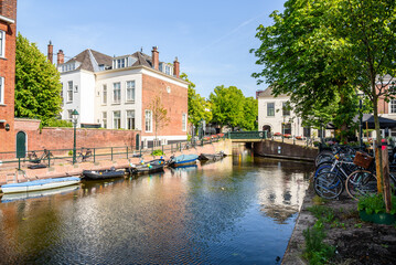 Fototapeta na wymiar Canal lined with residential and commercial buildings in The Hague city centre on a sunny summer day