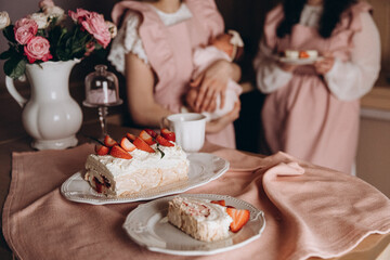 meringue cake combined with fresh strawberries on a background of a pink tablecloth