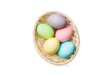 Basket of colorful Easter eggs isolated on white background. Easter basket filled with colored eggs top view holiday concept