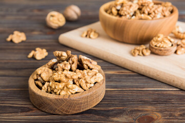 Fresh healthy walnuts in bowl on colored table background. Top view Healthy eating bertholletia concept. Super foods