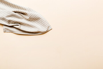 top view with gray kitchen napkin isolated on table background. Folded cloth for mockup with copy space, Flat lay. Minimal style
