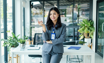 Asian woman entrepreneur with business success standing happily smiling in the office