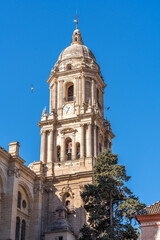 Fototapeta na wymiar Malaga Spain downtown old area with a church tower and blue sky