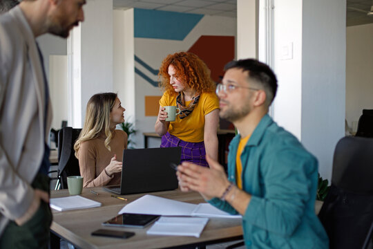 Happy team of environmentalists having a meeting at casual office.