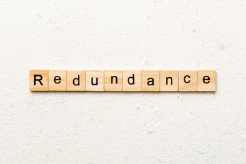 redundancy word written on wood block. redundancy text on table, concept