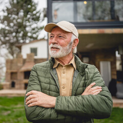 One senior man stand outdoor in front of his house happy confident