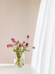 Pink Oleander Flowers in a Glass Vase, Swirling Curtain in the Background.