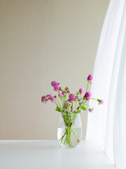 Pink Oleander Flowers in a Glass Vase, Swirling Curtain in the Background.	