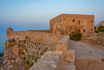 Sunset view of buildings at Venetian Fortezza Castle in Greek town Rethimno, Crete