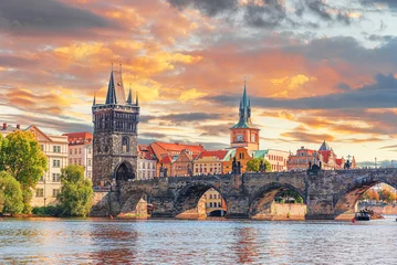Foto op Plexiglas Prague - Charles bridge, Czech Republic. Scenic aerial sunset on the architecture of the Old Town Pier and Charles Bridge over the Vltava River in Prague, Czech Republic. © Denis Rozhnovsky