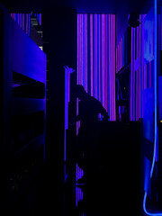 Silhouette in dark room with fluorescent neon lights