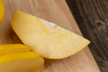 Sliced ripe yellow quince on a cutting board