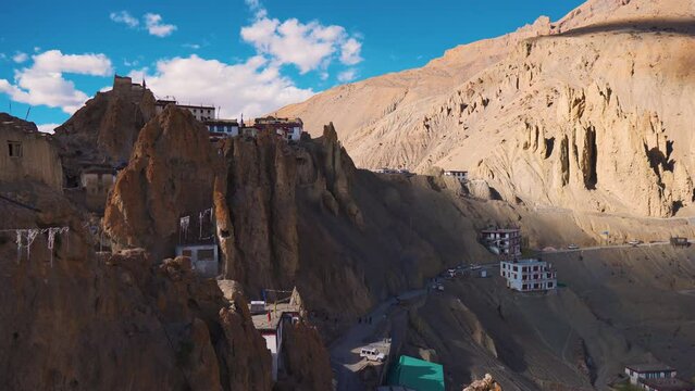 4K shot of Dhankar Monastery at Dhankar Village between Kaza and Tabo at Spiti Valley in Himachal Pradesh, India. View of old monastery with houses of village on a cliff. Old homes on side of cliff. 