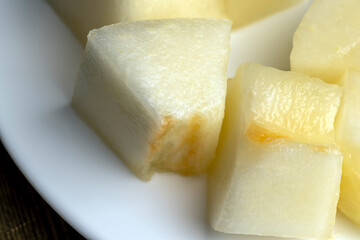 Ripe yellow melon cut into pieces and portions
