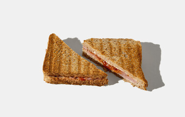 Toasted sandwich cut in half on white background. Minimal horizontal composition, homemade fast food concept