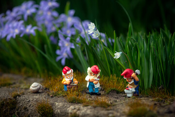 Fairy tale character.Gnomes in the spring garden.Fairy landscape with children's figurines.
