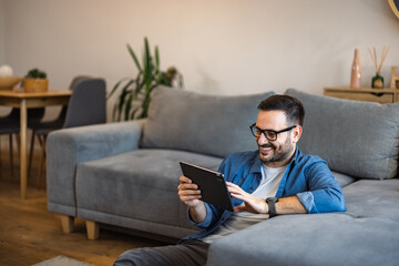 Smiling businessman having an online meeting with colleagues, indoors.