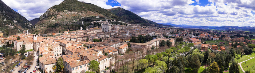 Fototapeta na wymiar Aerial drone panoramic view of medieval town Gubbio in Umbria. Italy travel .great historical italian landmarks and best tourist destinations