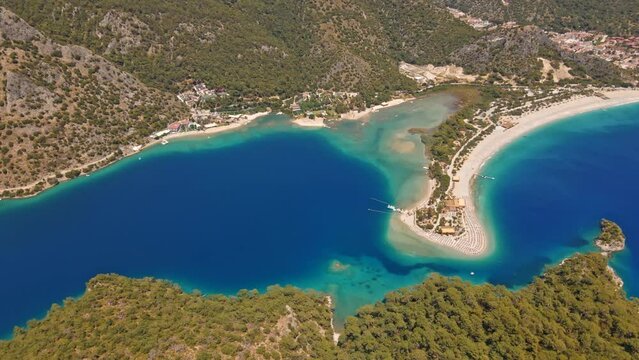 Oludeniz is a resort village on the southwest coast of Turkey. known for the blue lagoon of Oludeniz Tabiat Parki and the wide, white Belcekiz Beach.