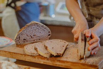 cutting slice of homemade bread