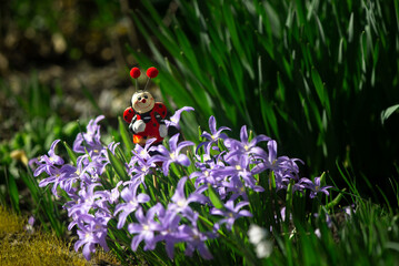 Floral landscape with a fairy-tale character.Mushroom meadow with bright flowers.Bee character in...