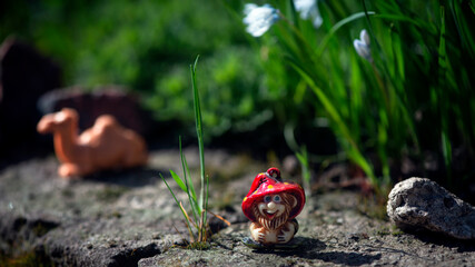 Camel and dwarf in a fairy garden.Fairy story.
Floral landscape with a fairy-tale character.