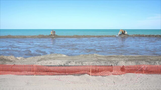 Timelapse of the work of two excavators for beach nourishment