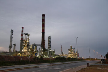 Oil refinery by the street at dawn