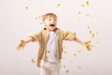 Happy child boy celebrating a birthday party with confetti. Party concept. Kids birthday