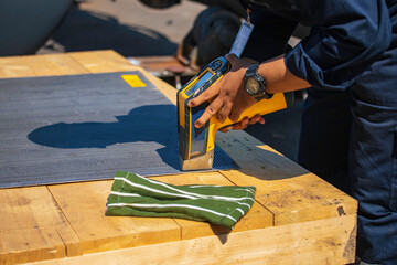 Male worker inspecting surface on plate stainless