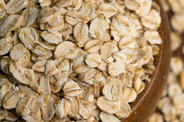 Oat flakes scattered on a wooden surface