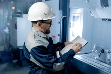 Worker caucasian engineer professional man control CNC machinery on industry factory
