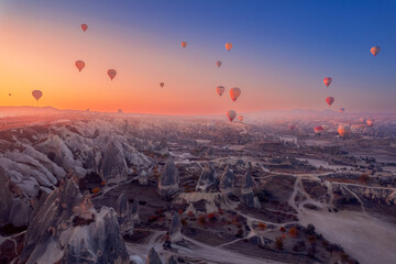 Colorful hot air balloons fly, Amazing sunrise Cappadocia, Goreme national park. Turkey travel Concept, aerial view