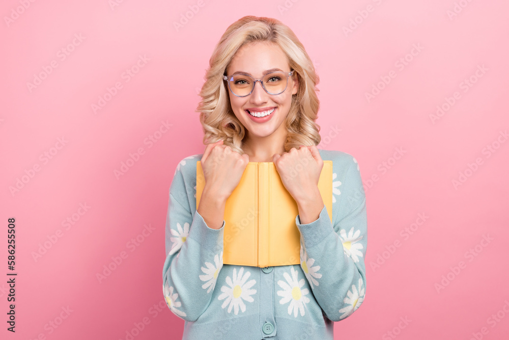 Sticker Photo of young girl glasses hugs favorite book from store nerd academic wear daisy flower print shirt isolated on pink color background