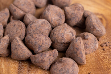 a large number of sweet candies in chocolate powder