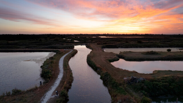 pink sunrise over the salt tides of the island of oleron © sully