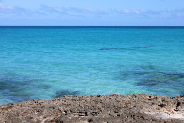 View to blue ocean from stone coast. Seascape with azure water